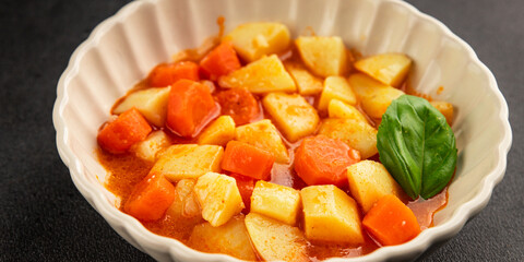 Stewed potatoes with carrots vegetarian side dish fresh delicious gourmet food background on the table rustic food top view copy space keto and paleo diet vegan food