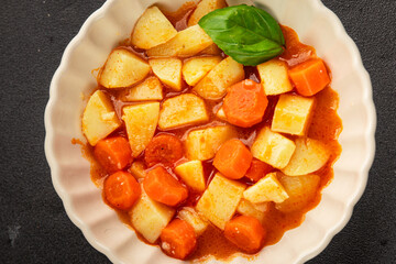 Stewed potatoes with carrots vegetarian side dish fresh delicious gourmet food background on the...
