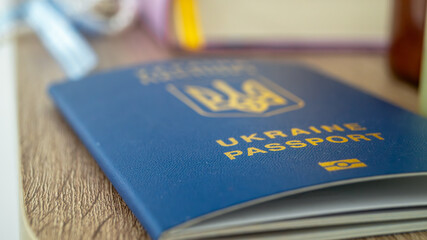 Close-up of a blue passport lying on a wooden surface. Passport of Ukraine macro