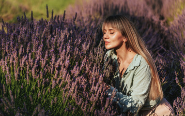 Woman in Lavender Field Smelling Purple Flowers