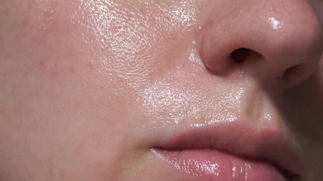 Extreme close-up of facial skin showing natural pores, glow and texture. Ideal for skincare, dermatology, real beauty, and cosmetic product demos or medical illustrations.