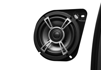Close up of a car audio speaker with a black frame and silver accents against a white background