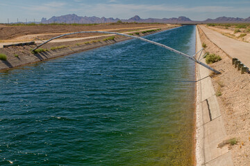 View of an aqueduct filled with water in a desert setting