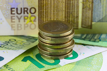 Banknotes with a stack of coins arranged on them, Euro currency