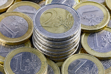 Coins denominated in euro are lying in a pile