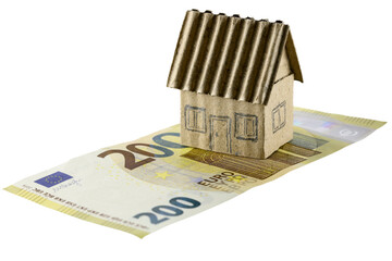 Paper model of a small house and a European Union banknote
