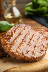 Delicious hamburger patties and spices on table, closeup