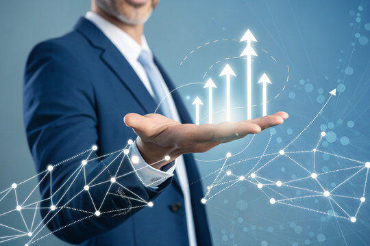 "Corporate-style image of a light-skinned man in his 40s wearing a navy-blue suit, mid-shot perspective. He is centrally framed with his hand extended, palm upward, presenting a holographic web of whi - Powered by Adobe