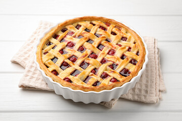 Tasty cherry pie on white wooden table