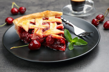 Piece of tasty cherry pie and berries on grey table, closeup