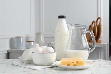 Different dairy products and eggs on white marble table indoors. Space for text