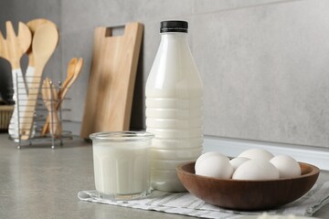 Dairy products and eggs on gray textured table in kitchen