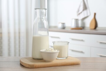 Dairy products. Fresh milk and cottage cheese on wooden table in kitchen