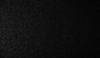 Abstract textured dark background with subtle white speckled patterns and diagonal lines