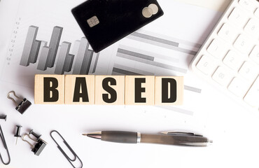 Wooden blocks with word based on financial documents with pen, credit card, calculator and office...