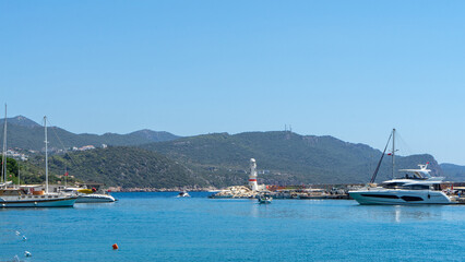 View of lighthouse in marina of Kas, Turkey. Active recreation and boat trips in Mediterranean Sea