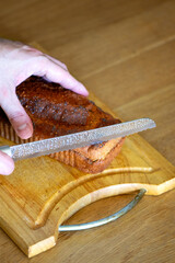 Homemade loaf of poppy seed bread on wooden cutting board