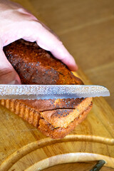 Homemade loaf of poppy seed bread on wooden cutting board