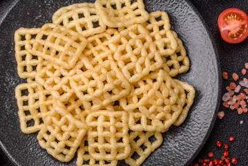 Lattice or wafer potato chips, crispy yellow snacks, takeaway food