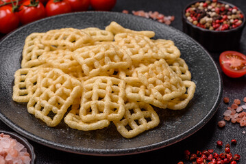 Lattice or wafer potato chips, crispy yellow snacks, takeaway food