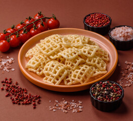 Lattice or wafer potato chips, crispy yellow snacks, takeaway food