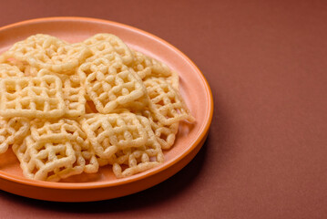 Lattice or wafer potato chips, crispy yellow snacks, takeaway food