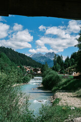 Avisio River Flowing Through Moena, Trentino, Italy Seen from a Bridge