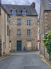 Narrow Stone Street with Traditional French Building and Road Signs