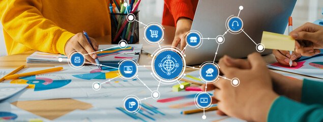 A vibrant workspace featuring hands collaborating on projects with colorful stationery and a...