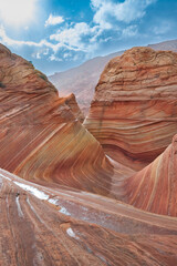 The Wave in Vermilion Cliffs, USA, showcases surreal sandstone formations with wave-like patterns...