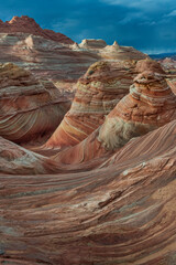 The Wave in Vermilion Cliffs, USA, showcases surreal sandstone formations with wave-like patterns...