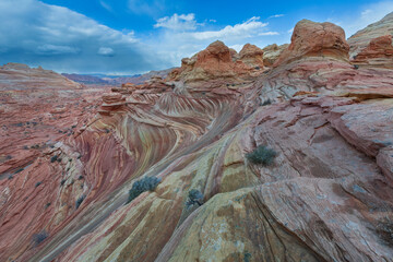 The Wave in Vermilion Cliffs, USA, showcases surreal sandstone formations with wave-like patterns...