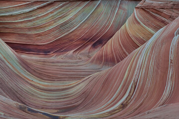 The Wave in Vermilion Cliffs, USA, showcases surreal sandstone formations with wave-like patterns...