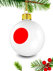 Japanese flag on christmas ornament hanging on pine tree branch