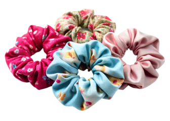 Four colorful scrunchies in floral and solid colors isolated on transparent background