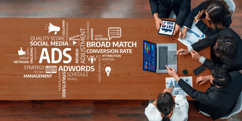 A team of professionals engages in a business meeting discussing advertising strategies, utilizing digital tools and analytics to optimize performance and drive success. Amity