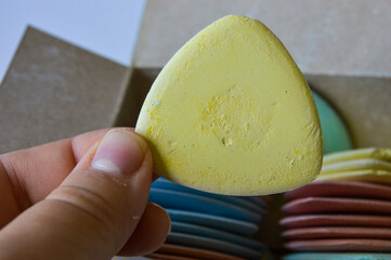 colorful tailor's chalks neatly arranged in a cardboard box, ideal for sewing, dressmaking, or...