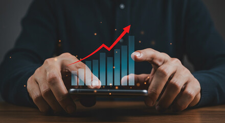 Person holding phone with upward trending bar graph and red arrow overlayed on the screen display