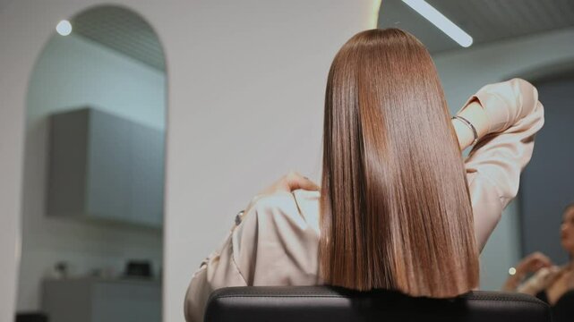 Woman after keratin haircare procedure. Healthy hair care treatment in salon.