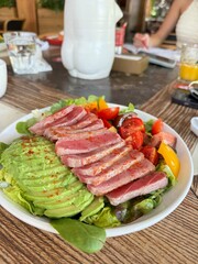 Fresh Tuna Salad with Avocado and Cherry Tomatoes on Wooden Table