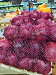 A pile of onions in a store