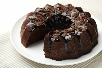 Delicious chocolate bundt cake on light table, closeup