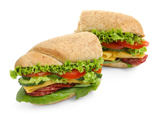 Pieces of tasty baguette sandwich with smoked sausage, cheese and vegetables isolated on white