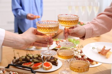 Buffet menu. Women toasting at table, closeup