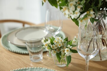 Bouquet of beautiful jasmine flowers on dining table indoors, closeup
