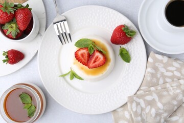 Tasty panna cotta served on light table, flat lay