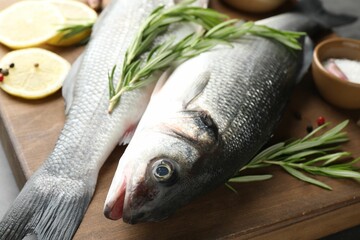 Fresh raw seabass with spices on table, closeup. Fish and seafood delicacies