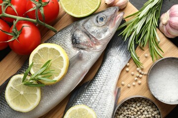 Fresh raw seabass with spices on table, closeup. Fish and seafood delicacies