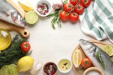 Frame of fresh raw seabass fish with spices on white wooden table, flat lay and space for text....