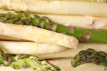 Different raw asparagus spears as background, top view